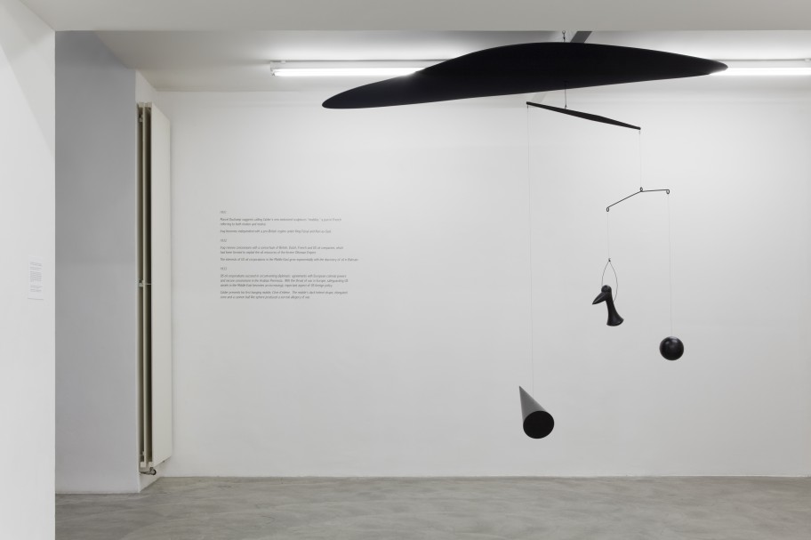 Alessandro Balteo-Yazbeck & Media Farzin  Model of Alexander Calder’s Cône d’ébène, 1933 + Saddam Cloud. From the series Modern Entanglements, U.S. Interventions, 2006-2009Ebonized wood, metal, synthetic fabric and thread, vinyl lettering on wall and wall label with narrative text Installation dimensions variable 